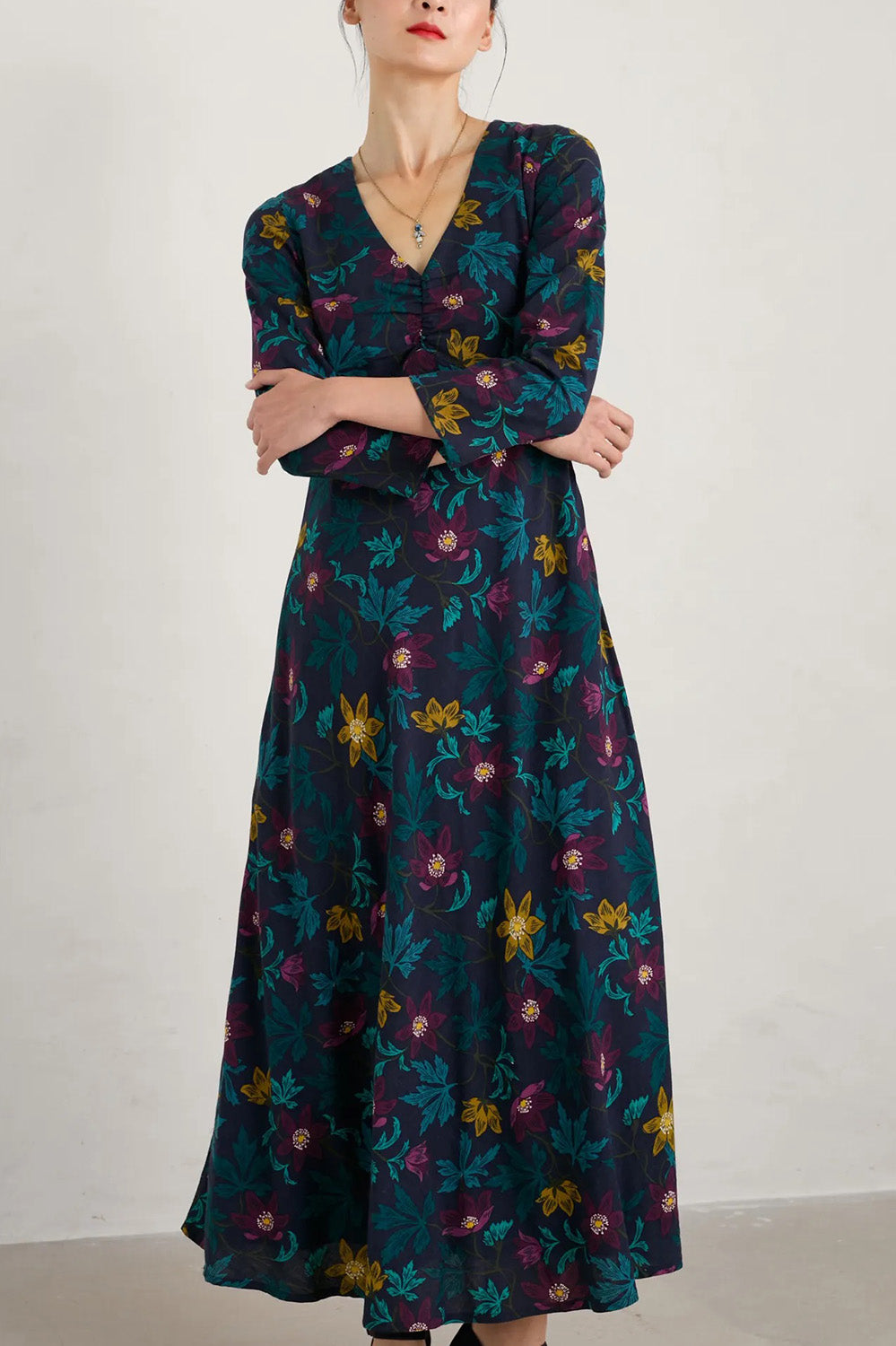 A model wearing the Willow Blossom Dress in colour Floral (Blue), from the front, cropped image