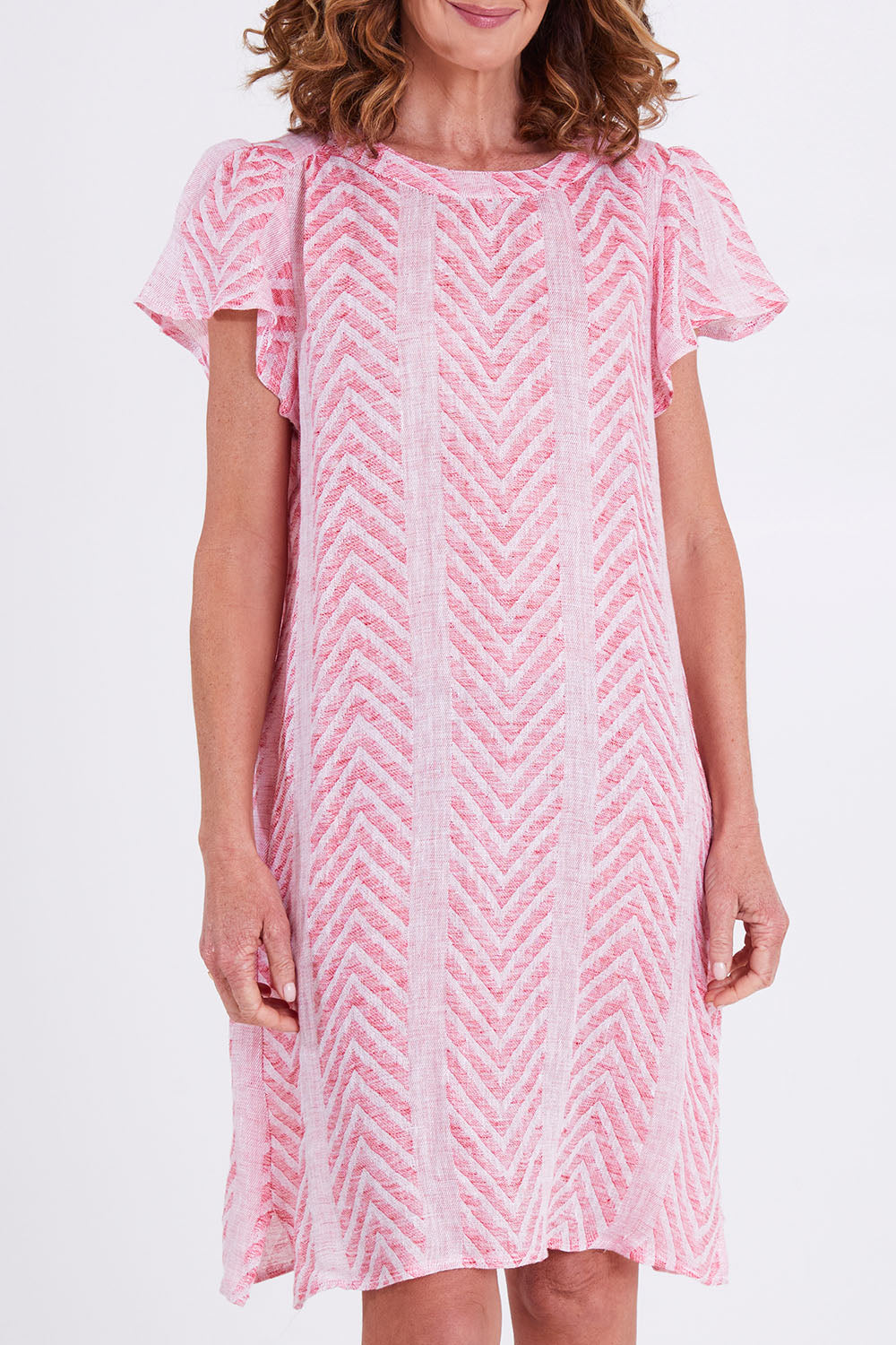 Model Emma wearing size 10 of the Flutter Sleeve Dress in colour Redwhite (Red), from the front, cropped image