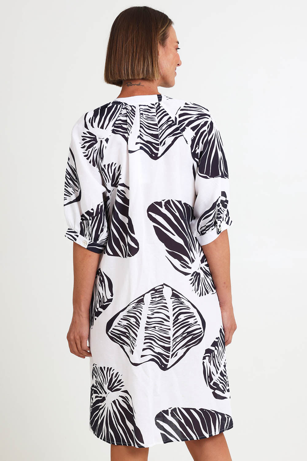 Model Riinar wearing size 10 of the Shell Button Front Dress – Shell in colour Shell, from the back