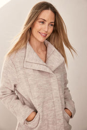 A model wearing the Longline Panel Zip Boiled Wool Coat in colour Natural, from the front, cropped image