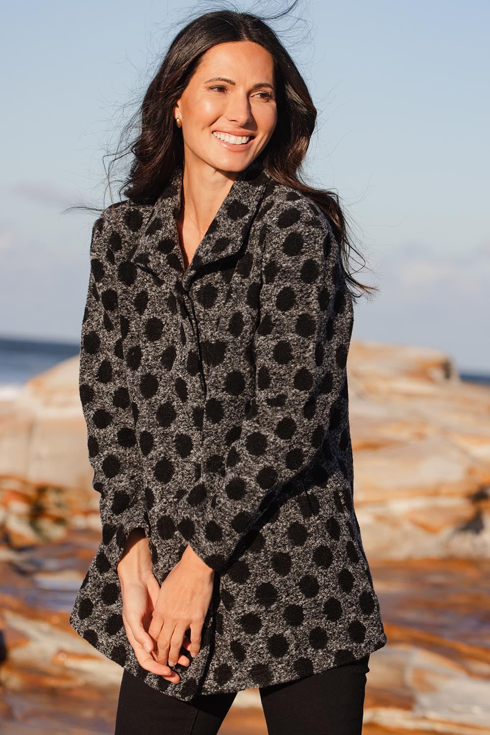 A model wearing the Spot Funnel Neck Boiled Wool Coat in colour Blackspot (Grey), from the front, showing the whole outfit
