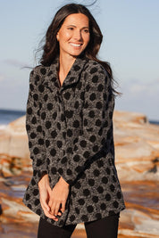 A model wearing the Spot Funnel Neck Boiled Wool Coat in colour Blackspot (Grey), from the front, showing the whole outfit