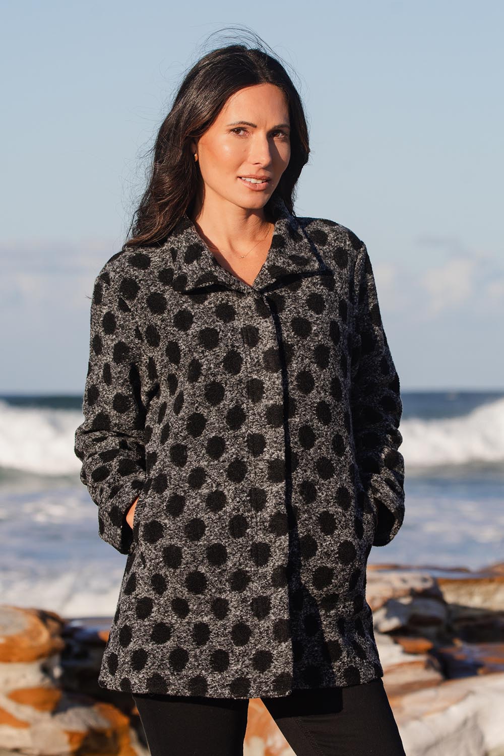 A model wearing the Spot Funnel Neck Boiled Wool Coat in colour Blackspot (Grey), from the front, showing the whole outfit