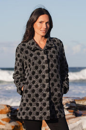 A model wearing the Spot Funnel Neck Boiled Wool Coat in colour Blackspot (Grey), from the front, showing the whole outfit