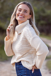 A model wearing the Wave Knit Roll Neck Cotton Blend Sweater in colour Vanilla, from the front, showing the whole outfit
