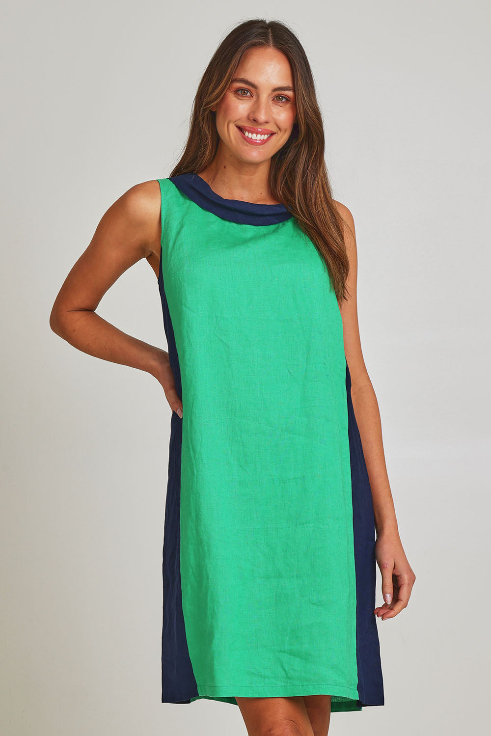 Model Madeline wearing size 10 of the Sl Cowl Neck Splice Shift Linen Dress in colour Greennavy (Green), from the front, cropped image
