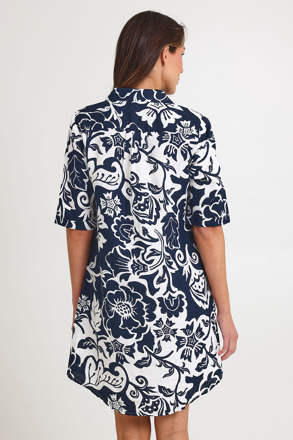 Model Madeline wearing size 10 of the Vine Linen Shirtmaker Dress in colour Vine (Blue), from the back