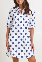 Model Madeline wearing size 10 of the Denim Spot Cotton Shirtmaker Dress in colour Denimspot (Blue), from the front, cropped image