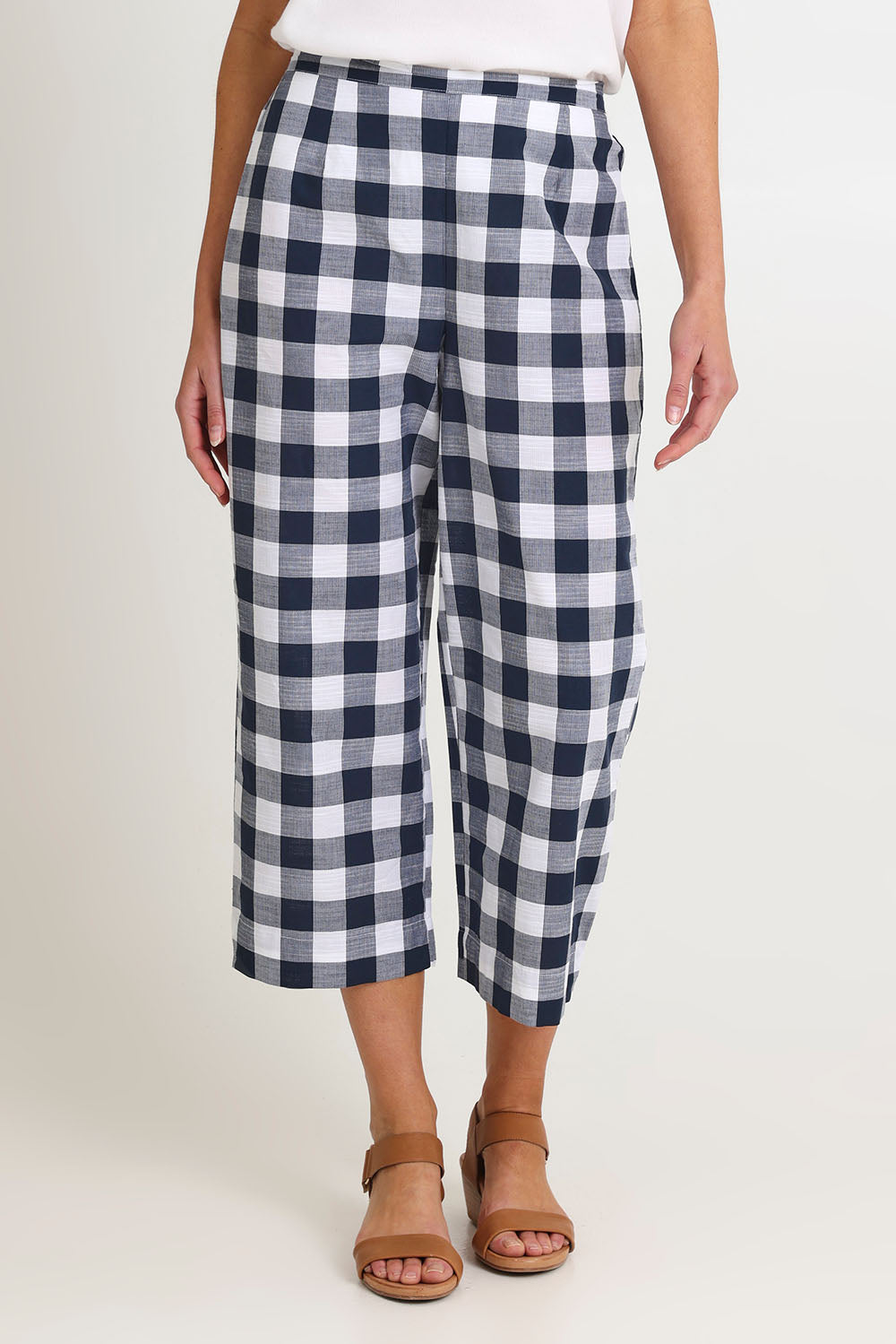 Model Madeline wearing size 10 of the 7/8 Flat Front Cotton Pant in colour Navy (Blue), from the front, cropped image