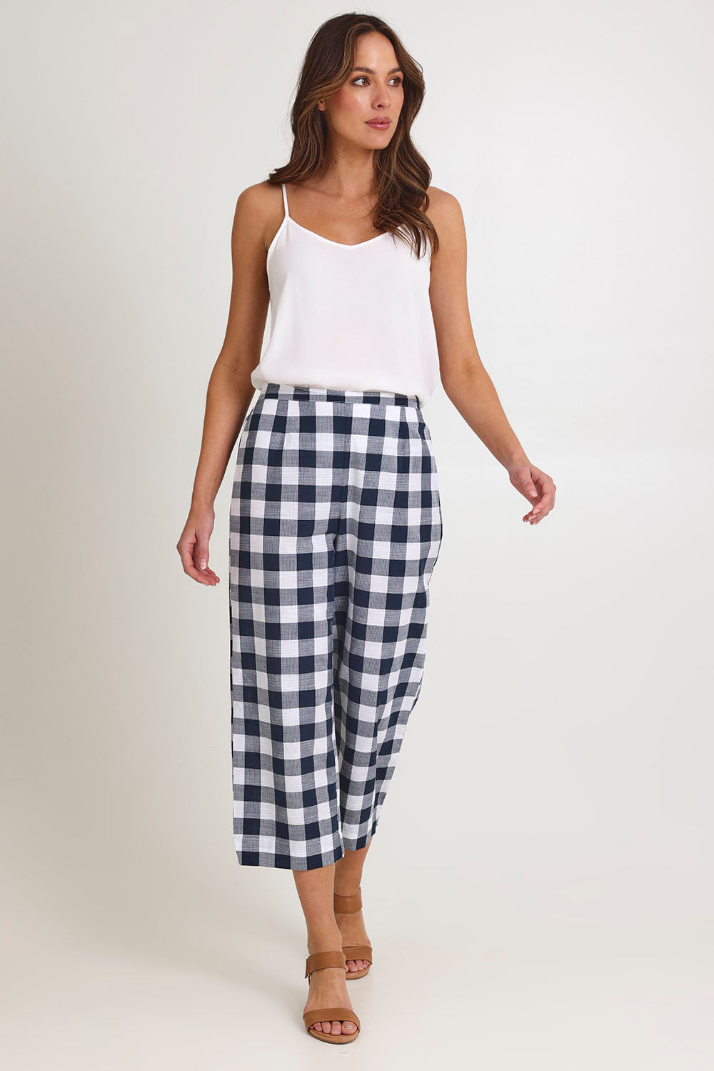 Model Madeline wearing size 10 of the 7/8 Flat Front Cotton Pant in colour Navy (Blue), from the front, showing the whole outfit