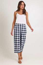 Model Madeline wearing size 10 of the 7/8 Flat Front Cotton Pant in colour Navy (Blue), from the front, showing the whole outfit