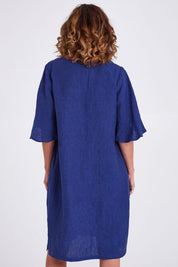 Model Emma wearing size 10 of the Flutter Sleeve Dress in colour Navy (Blue), from the back