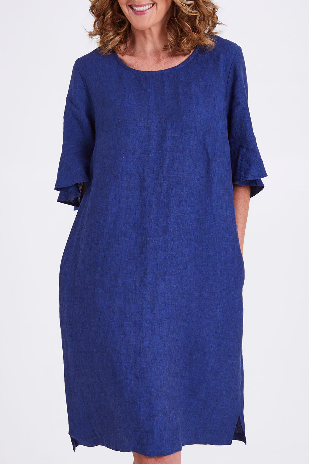 Model Emma wearing size 10 of the Flutter Sleeve Dress in colour Navy (Blue), from the front, cropped image
