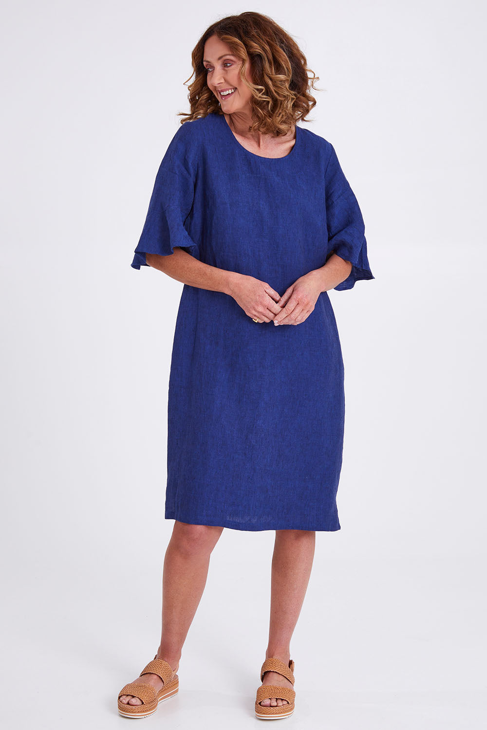Model Emma wearing size 10 of the Flutter Sleeve Dress in colour Navy (Blue), from the front, showing the whole outfit