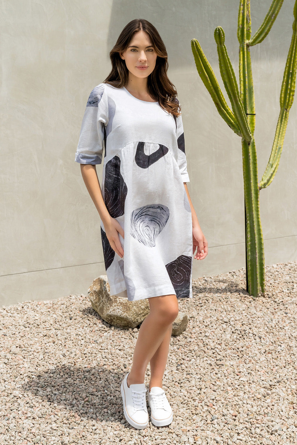 A model wearing the Linen 3/4 Sleeve Dress in colour Achromatic (White), from the front, showing the whole outfit