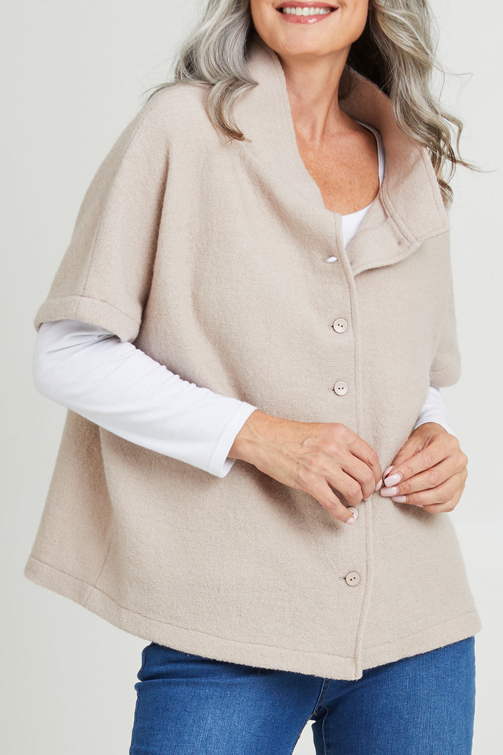 Model Luisa wearing size S of the Button Thru Vest in colour Stone, from the front, cropped image