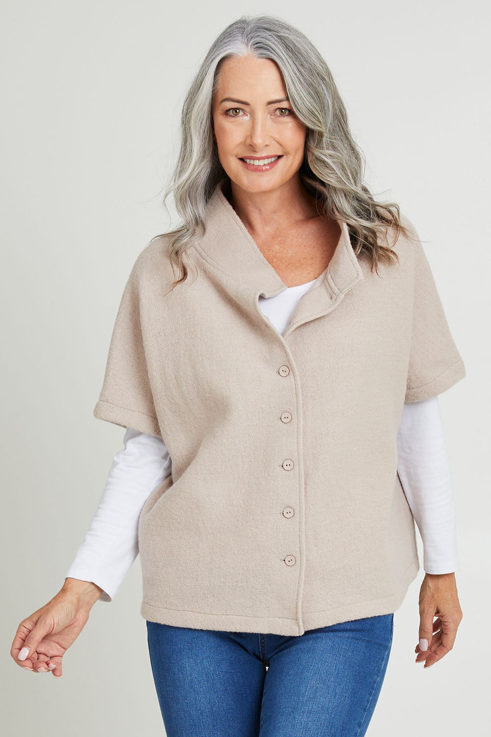 Model Luisa wearing size S of the Button Thru Vest in colour Stone, from the front, cropped image
