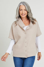 Model Luisa wearing size S of the Button Thru Vest in colour Stone, from the front, cropped image