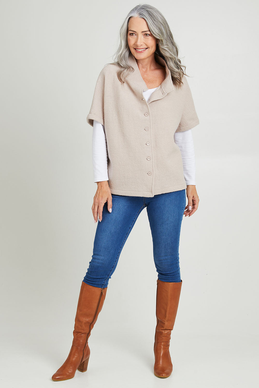 Model Luisa wearing size S of the Button Thru Vest in colour Stone, from the front, showing the whole outfit