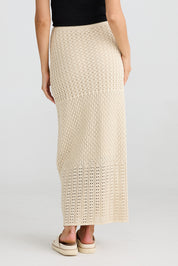 A model wearing the Kasbah Skirt in colour Natural, from the back