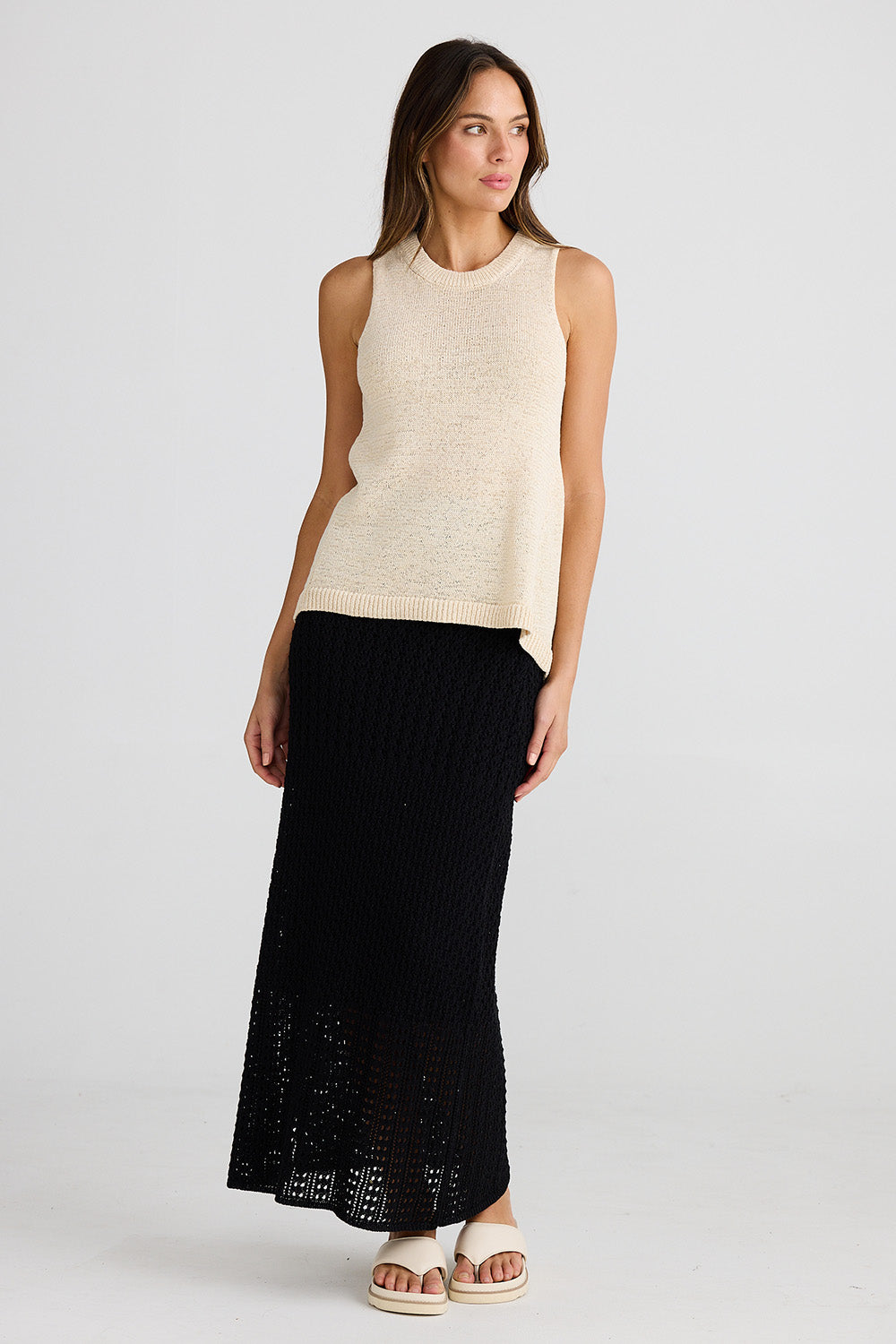 A model wearing the Issa Tank in colour Natural, from the front, showing the whole outfit