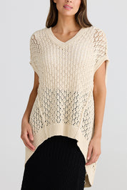 A model wearing the Kasbah Top in colour Natural, from the front, cropped image