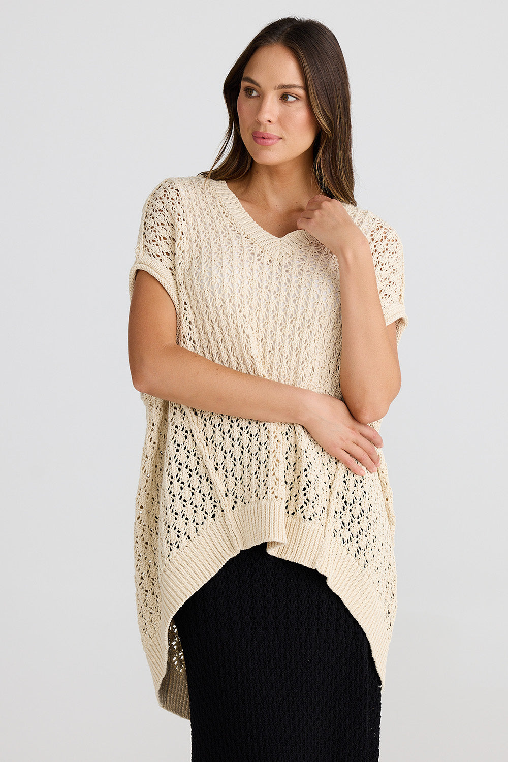 A model wearing the Kasbah Top in colour Natural, from the front, cropped image