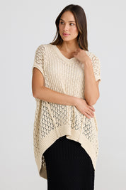 A model wearing the Kasbah Top in colour Natural, from the front, cropped image