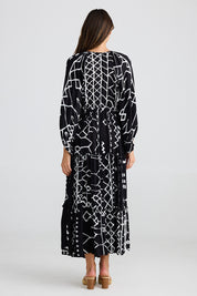 A model wearing the Wing And A Prayer Maxi in colour Blkindus (Black), from the back