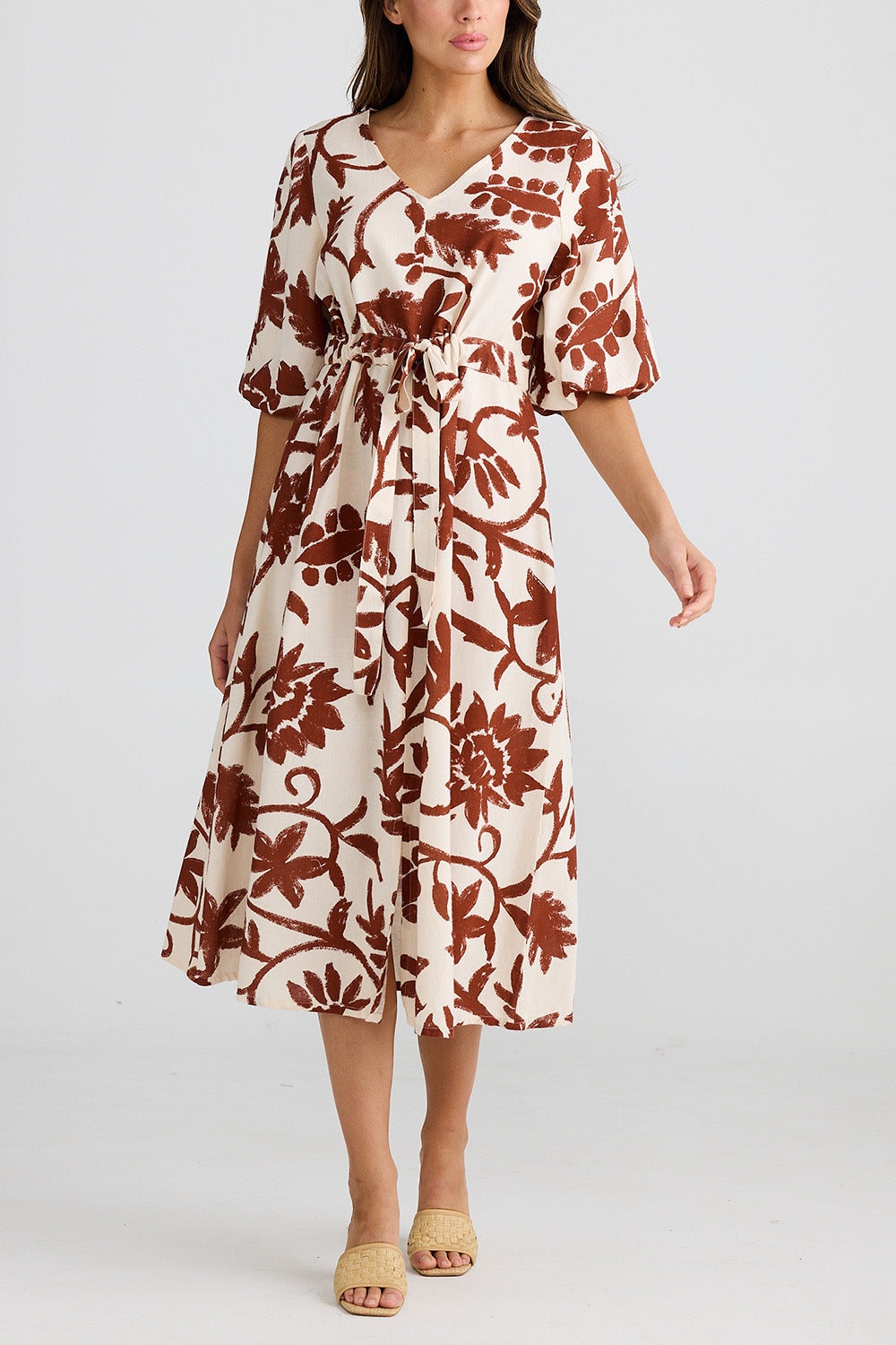 A model wearing the Ava Midi Dress in colour Cubanbloom, from the front, cropped image