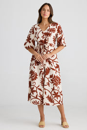 A model wearing the Ava Midi Dress in colour Cubanbloom, from the front, showing the whole outfit