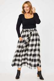 Model Jess wearing size L of the Natalia Skirt in colour Blkwhite (Black), from the front, showing the whole outfit