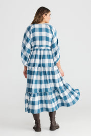 A model wearing the Wing And A Prayer Maxi Dress in colour Bluecheck (Blue), from the back