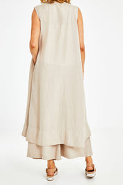 Model Naomi wearing the Neopolitan Long Vest in colour Natural, from the back