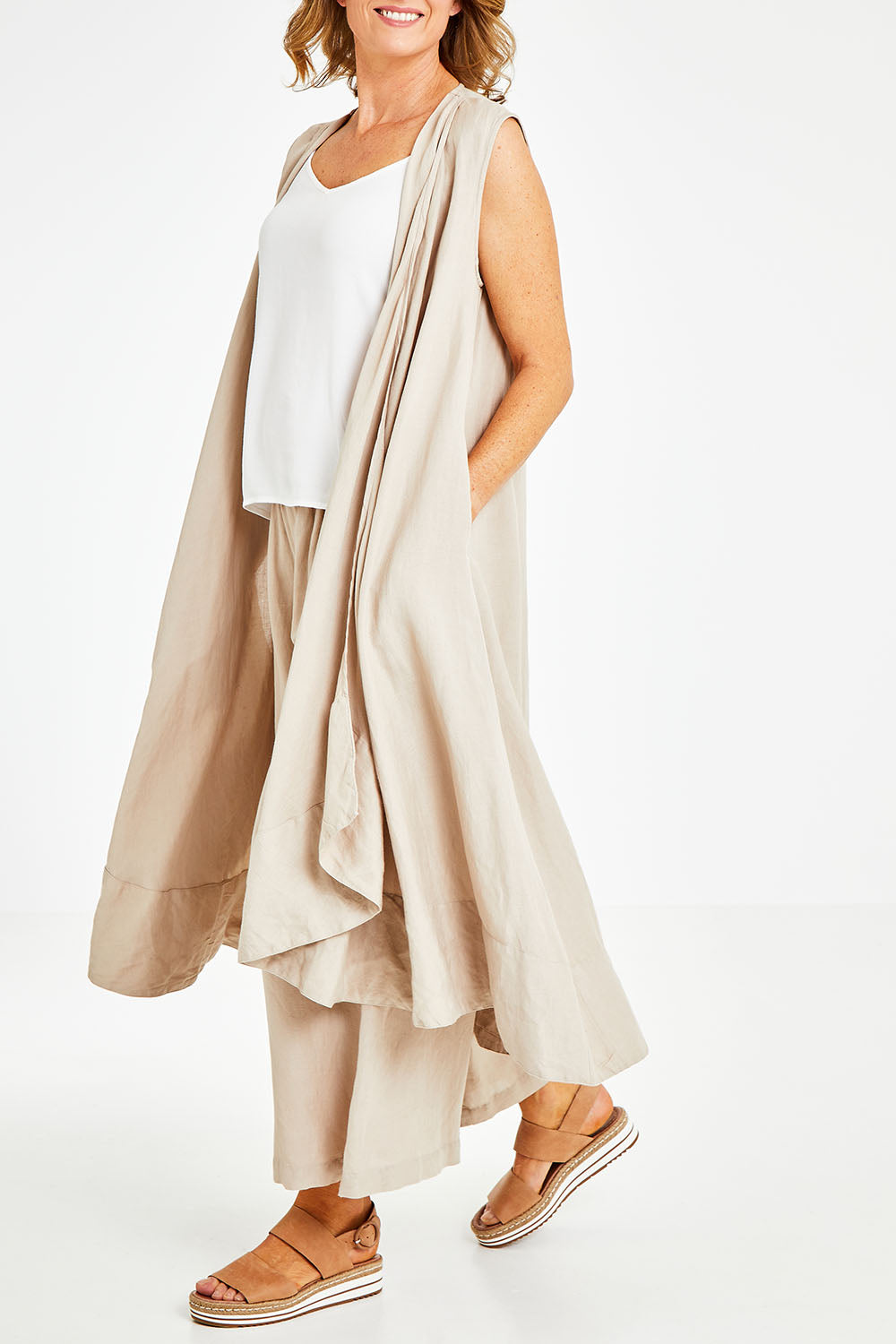 Model Naomi wearing the Neopolitan Long Vest in colour Natural, from the front, cropped image