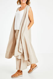 Model Naomi wearing the Neopolitan Long Vest in colour Natural, from the front, cropped image
