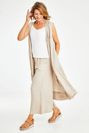 Model Naomi wearing the Neopolitan Long Vest in colour Natural, from the front, showing the whole outfit