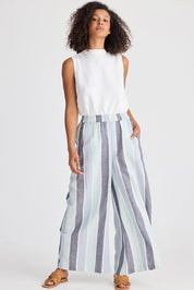 A model wearing the Positano Linen Cotton Pant in colour Tulipstrip (Blue), from the front, showing the whole outfit