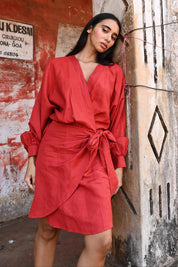 A model wearing the Porto Linen Dress in colour Cherry (Red), from the front, showing the whole outfit