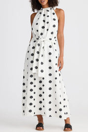 A model wearing the Lucia Linen Cotton Dress in colour Wovenspot (White), from the front, cropped image