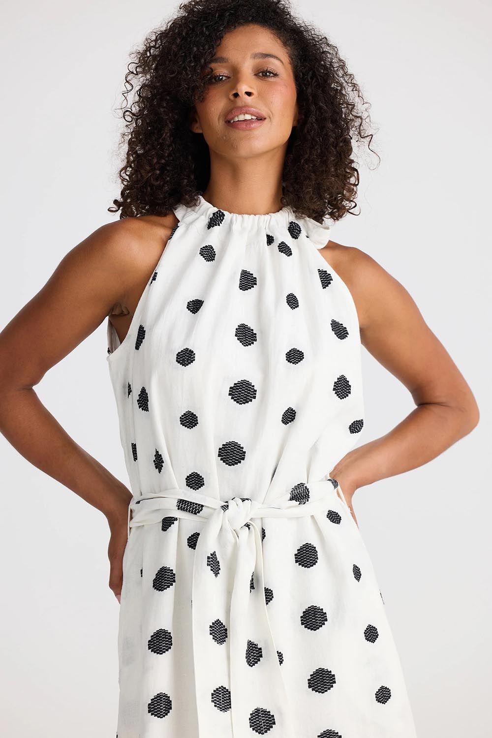 A model wearing the Lucia Linen Cotton Dress in colour Wovenspot (White), from the front, cropped image