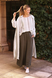A model wearing the Giorgio Coat Dress in colour Giardstri, from the front, showing the whole outfit