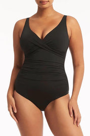 A model wearing the Eco Essentials Cross Front One Piece in colour Black (Black), from the front, cropped image