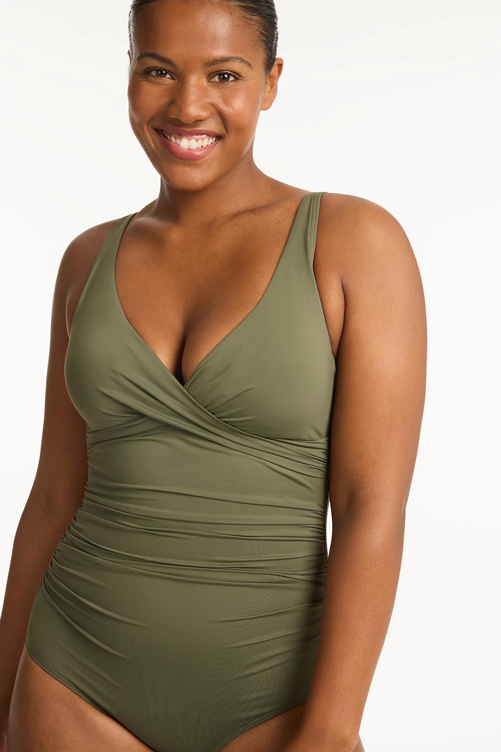 A model wearing the Eco Essentials Cross Front One Piece in colour Khaki (Green), from the front, cropped image