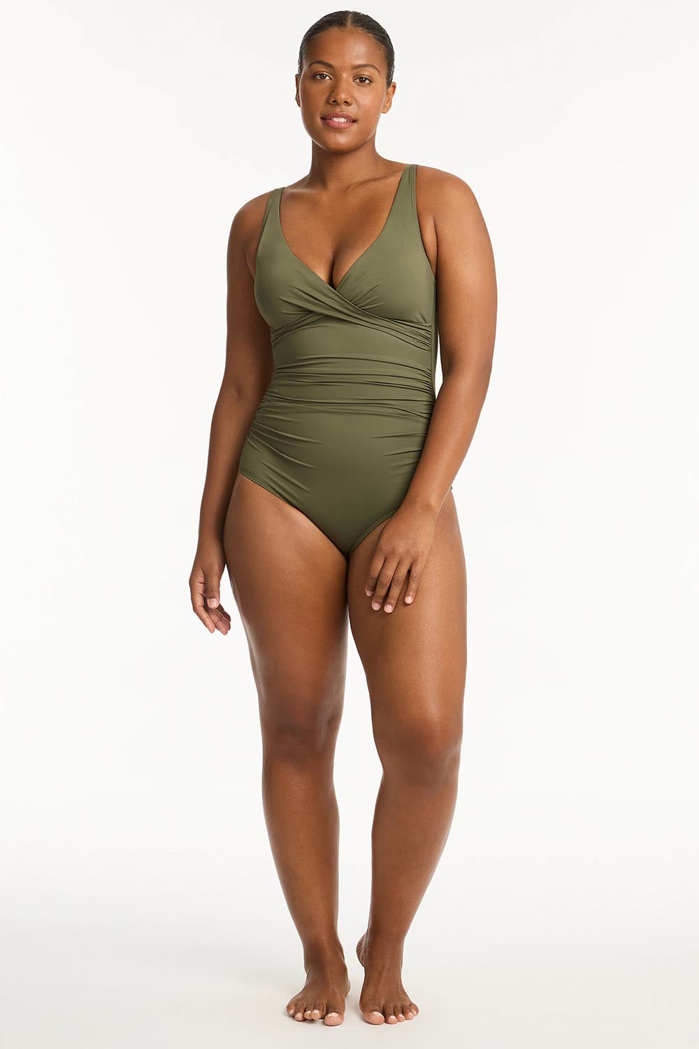 A model wearing the Eco Essentials Cross Front One Piece in colour Khaki (Green), from the front, showing the whole outfit