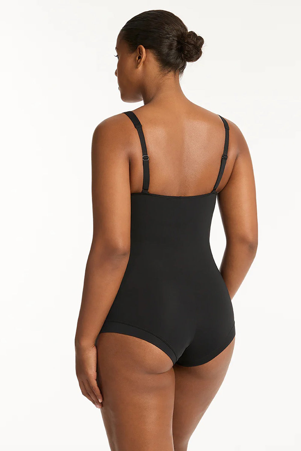 A model wearing the Twist Front Multifit Boy Leg One Piece in colour Black (Black), from the back