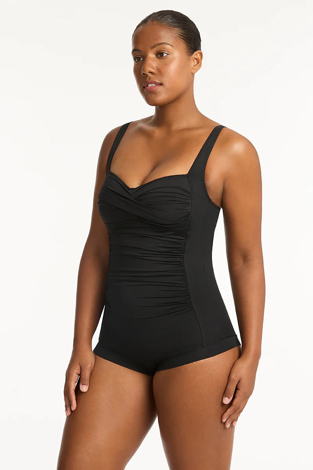A model wearing the Twist Front Multifit Boy Leg One Piece in colour Black (Black), from the front, cropped image