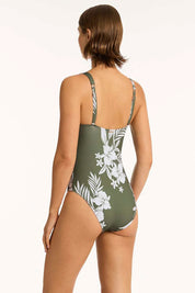 A model wearing the Longline Tri One Piece in colour Khaki (Green), from the back