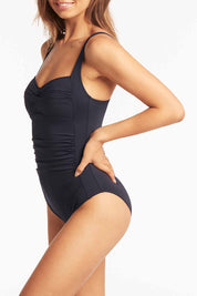A model wearing the Twist Front Multifit One Piece in colour Nightsky (Blue), from the front, cropped image