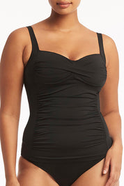 A model wearing the Twist Front Multifit Singlet Top in colour Black (Black), from the front, cropped image